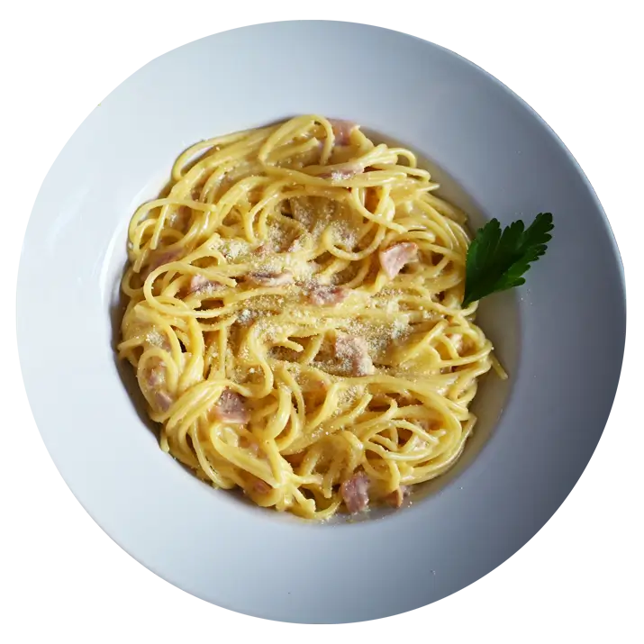 A plate of creamy pasta carbonara garnished with a sprig of parsley.